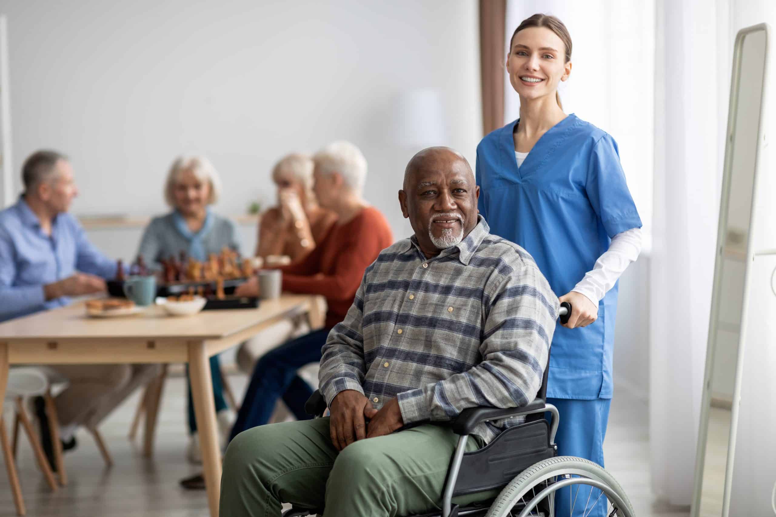 Nurse pushing man in a wheelchair Nurse pushing man in a wheelchair
